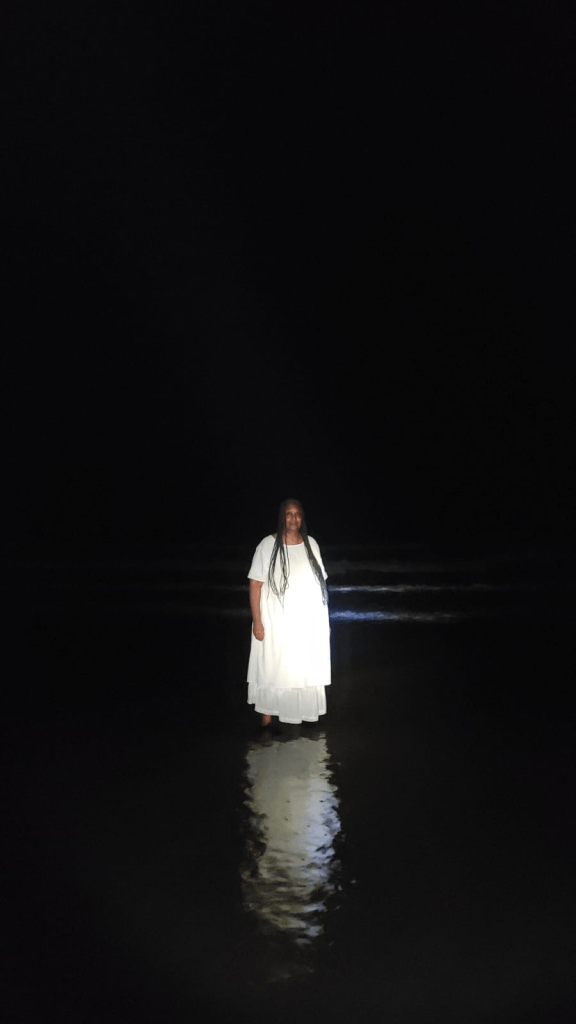 Me wearing white standing in ocean on Johns Island, SC
