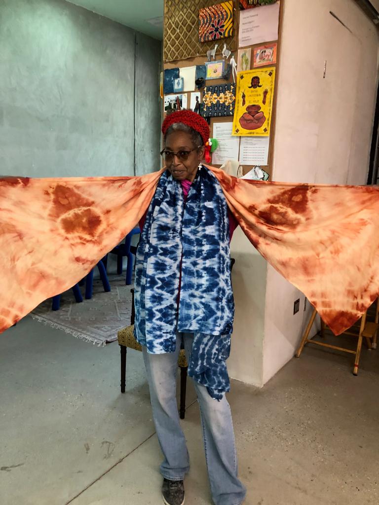 Photo of customer wearing red madder and indigo dyed silk scarves.