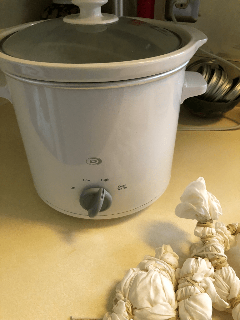 Photo of crockpot and dye bundles ready to dye.